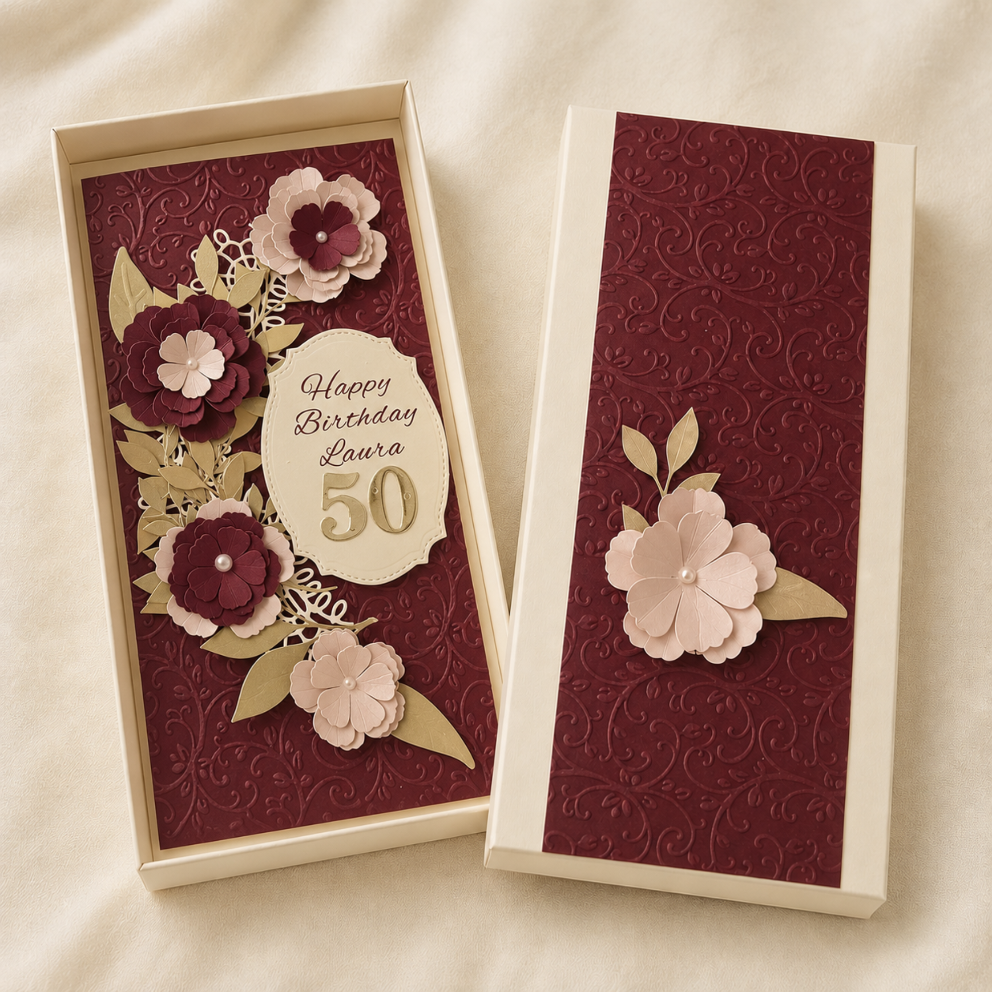 Personalised burgundy milestone birthday card displayed with matching gift box