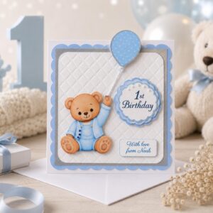 Personalised blue first birthday card for baby boy with handmade teddy bear design and custom name
